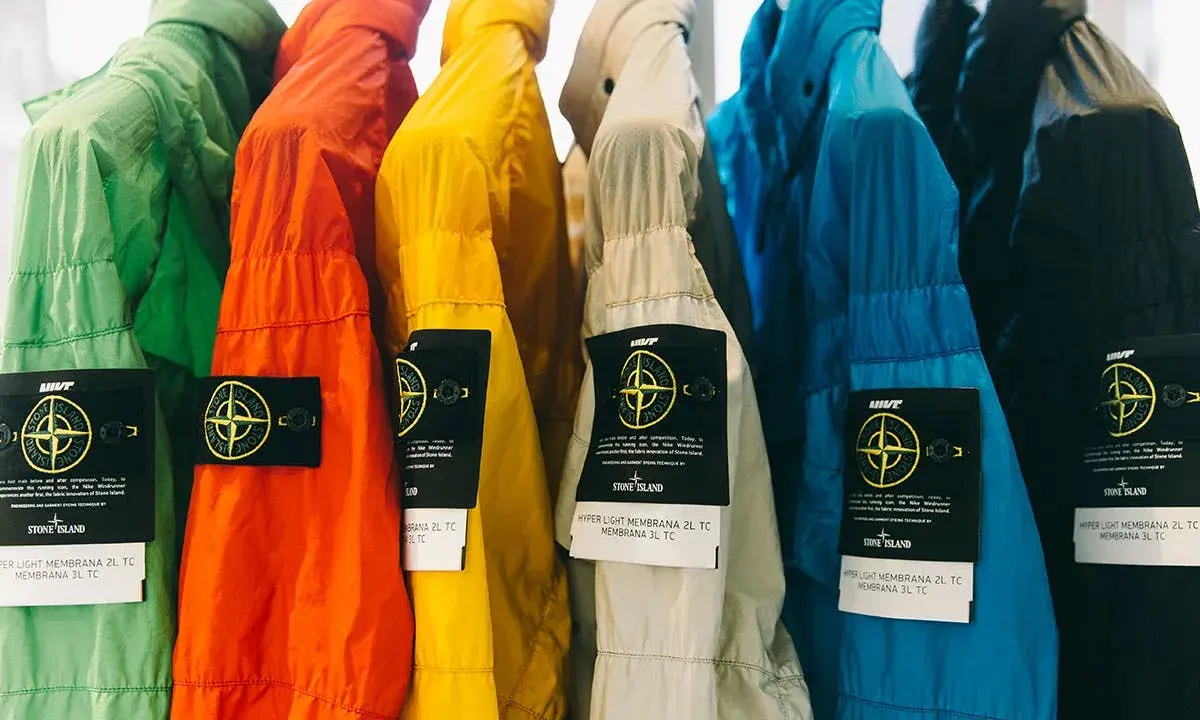 Bunte Stone Island Jacken mit dem ikonischen Patch. Ein Vergleich von Stone Island Patch original vs. fake ist hier gut erkennbar.