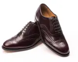Elegante, dunkelbraune Herrenschuhe im **full brogue** Stil mit Lochmuster und Schnürung.