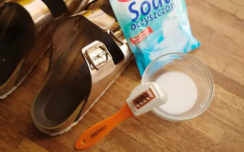 Birkenstock reinigen: Bürste, Reinigungsmittel und ein Paar Birkenstocks liegen bereit.