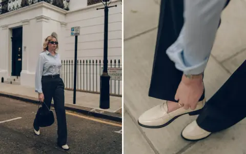 Schicke Loafer sind die perfekte Wahl für 3/4 Hosen. Eine Frau in einem gestreiften Hemd und dunklen Hosen trägt cremefarbene Loafer.
