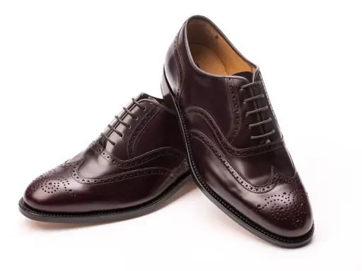 Elegante, dunkelbraune Herrenschuhe im **full brogue** Stil mit Lochmuster und Schnürung.